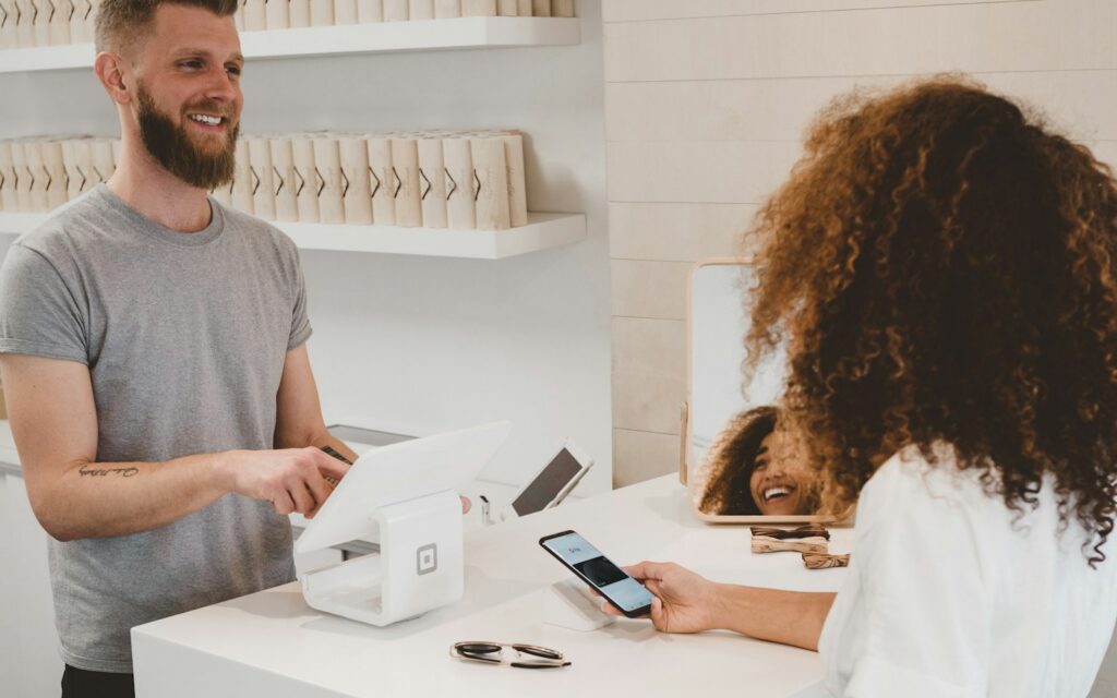 Customer paying with a mobile phone at a shop counter